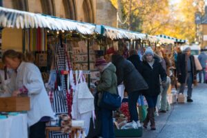 busy people shopping at a Christmas market on a Go Cotswolds tour.