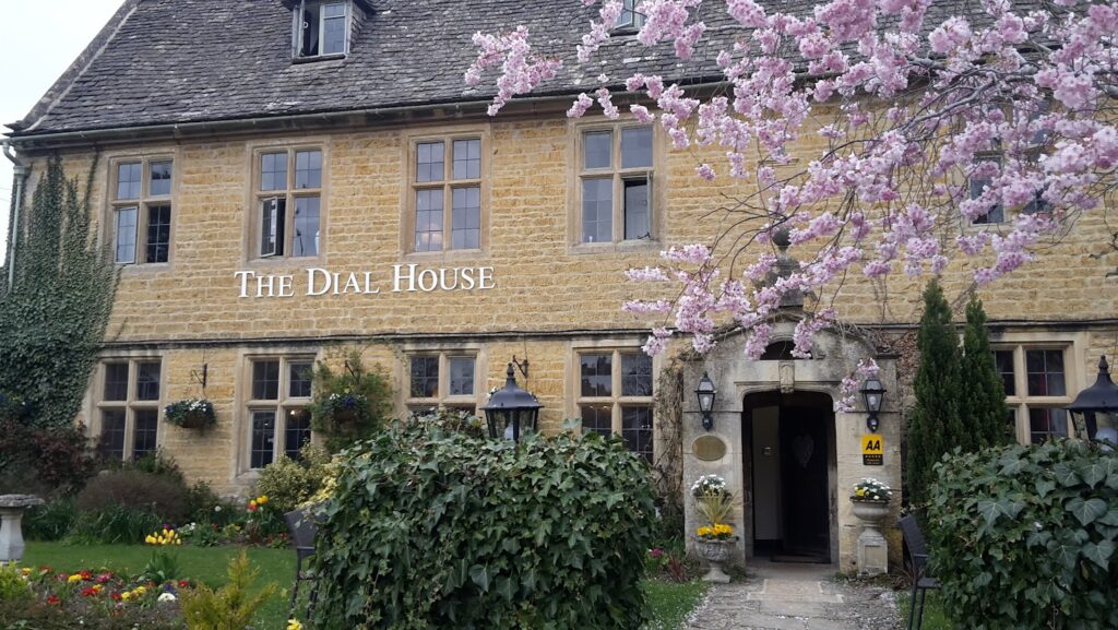 Blossom tree in bloom outside a Cotswolds stone pub in April