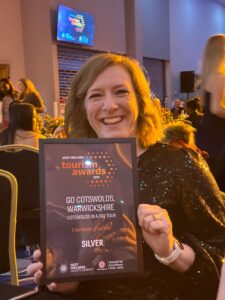 lisa holds up the Go Cotswolds awards from the West Midlands Tourism Awards 2025